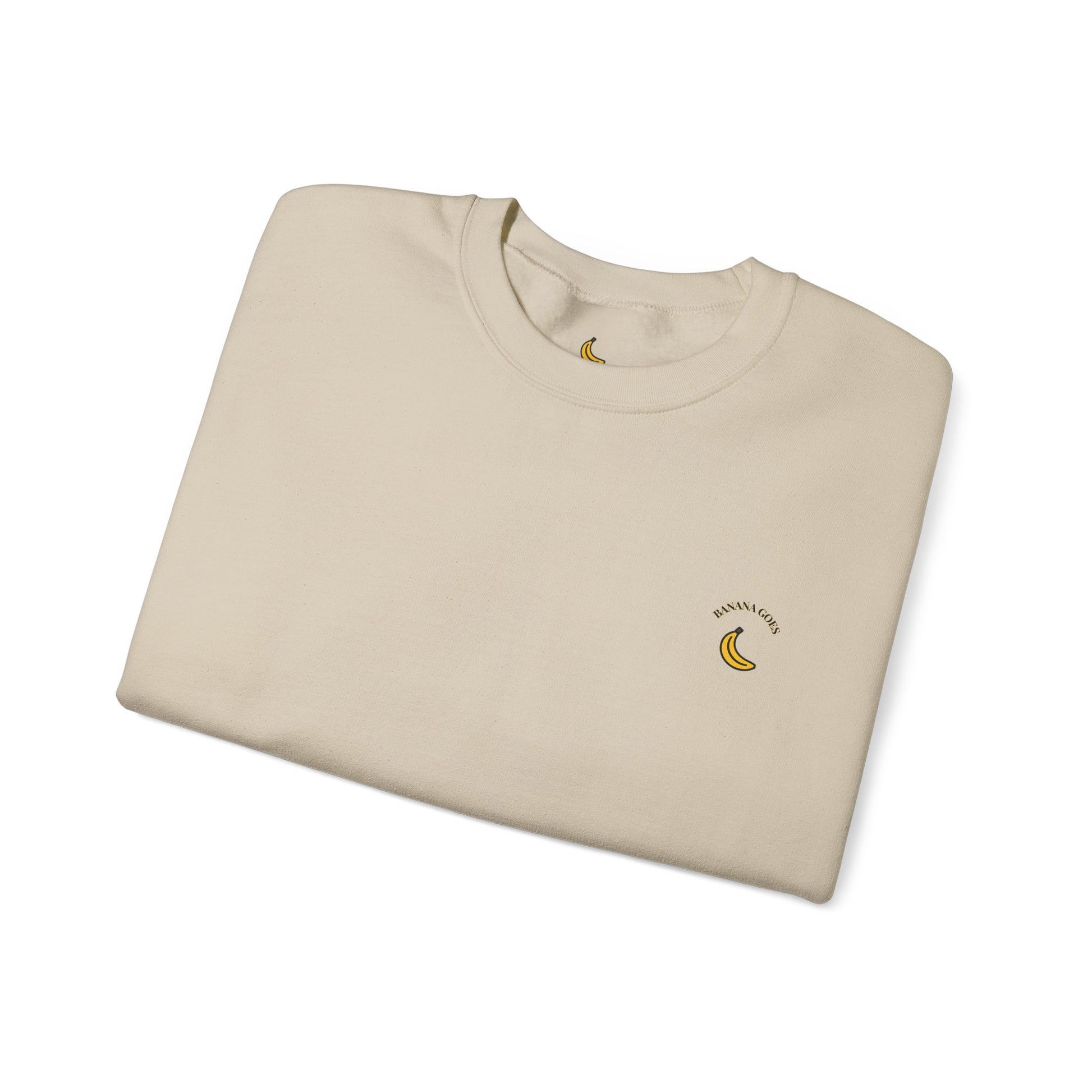 Folded beige sweatshirt with a banana logo on a white background