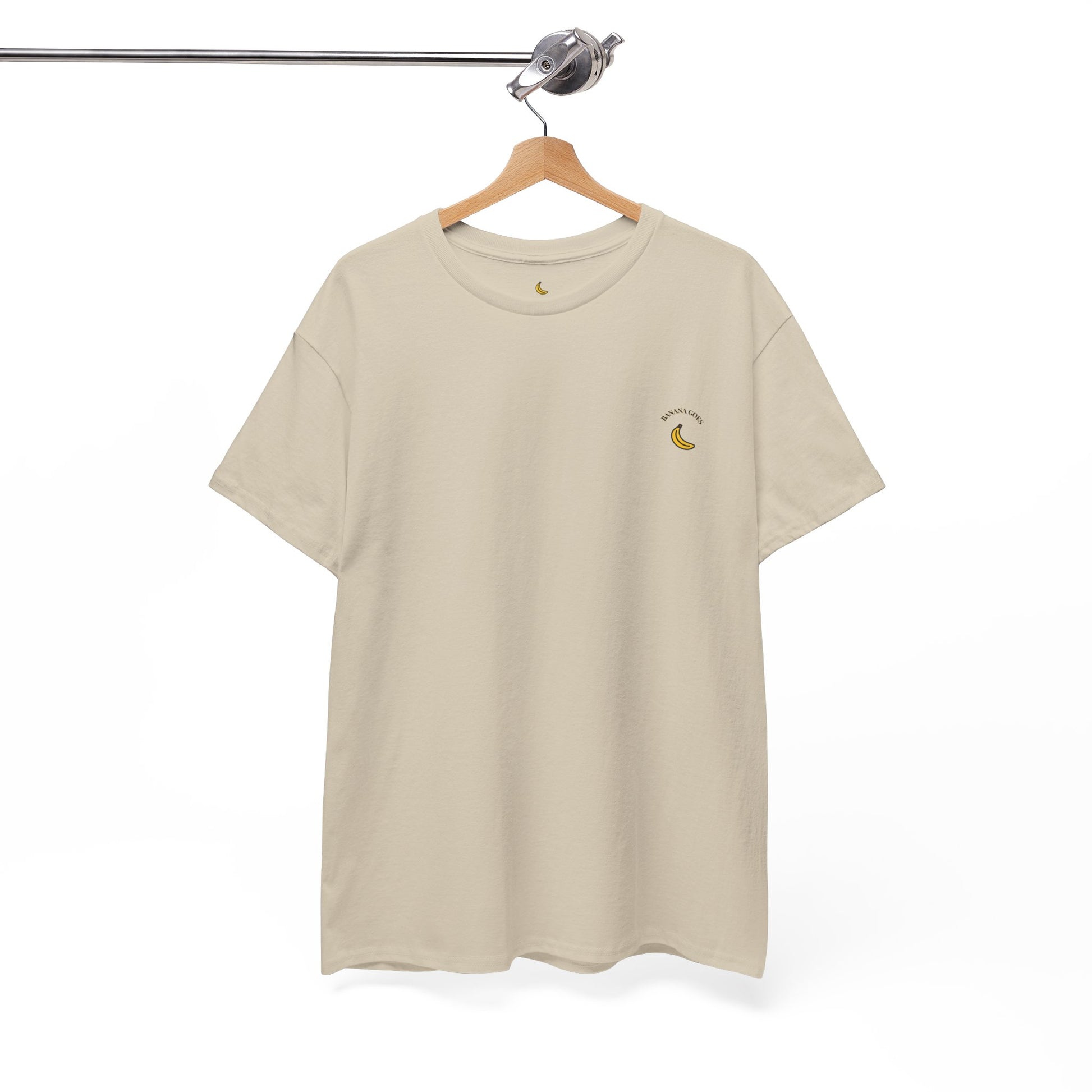 Beige t-shirt with a small logo on a hanger against a white background